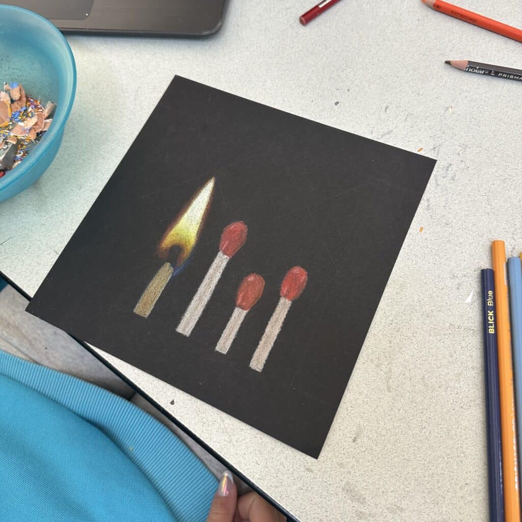 Drawing of fire is an easy thing to draw on black paper. This is an example of an easy high school art project.