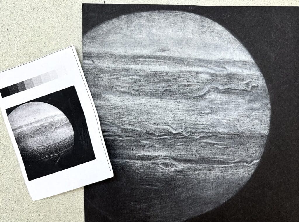 Student example of a high school art curriculum value drawing project showing a planet study with shading, texture, contrast, and a reference image.