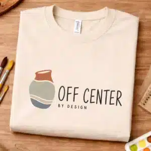 Pottery pun shirt featuring Off Center by Design
